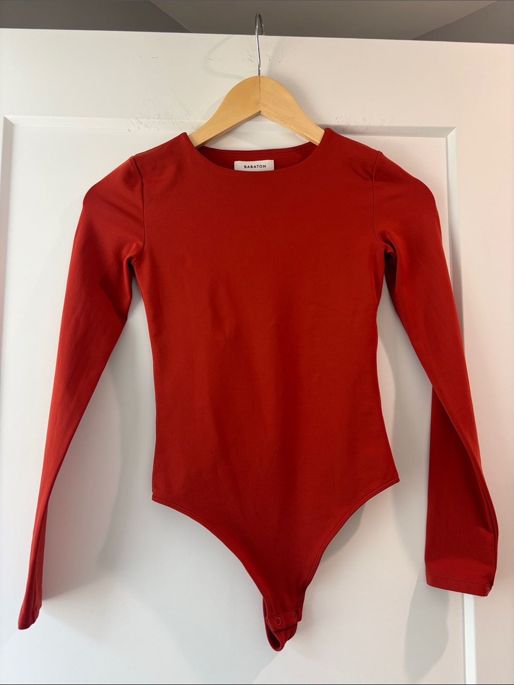 Babaton Long-Sleeve Blood Orange One-Piece Bodysuit